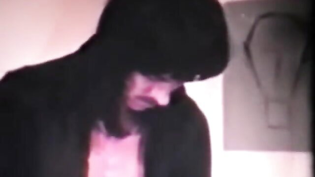 Vintage emo guy with long black hair in tight emo look, mysterious gaze