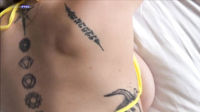 Angel Youngs sexy yellow thong, Sak Yant tattoos on hip, big tits side view