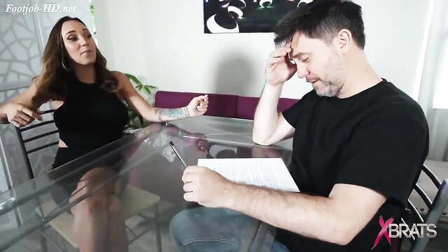 Sasha Foxxx inked brunette gives under desk footjob