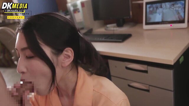 Sexy Asian woman in orange top giving closeup blowjob