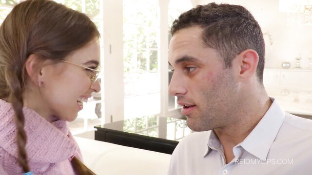 Teen girl with glasses in pink scarf smiles close to man in shirt