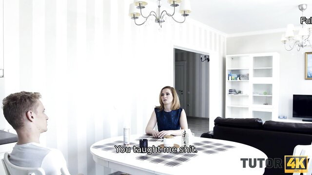 Tutor in blue dress teaches young student at table in 4K porn