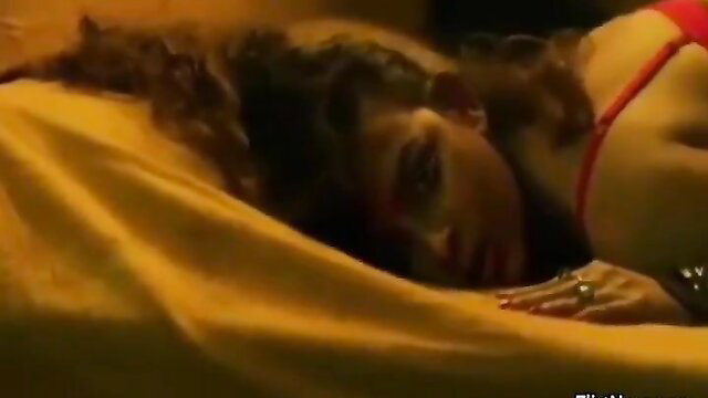 Curvy Indian wife in red lingerie lying on bed, intense bedroom eyes