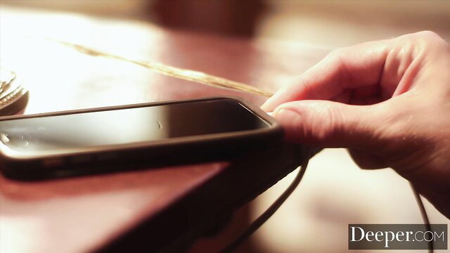 Kylie Rocket hand plugging in phone, sexy closeup from Deeper