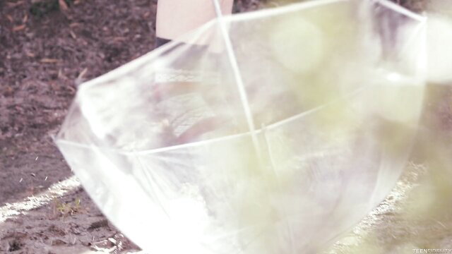 Alice Green with clear umbrella in Teenfidelity scene