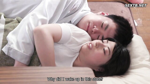 Asian couple sleeping nude spooning in bed after sex