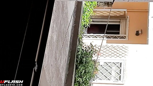 Amateur voyeur thumbnail of neighbor's orange house window with balcony