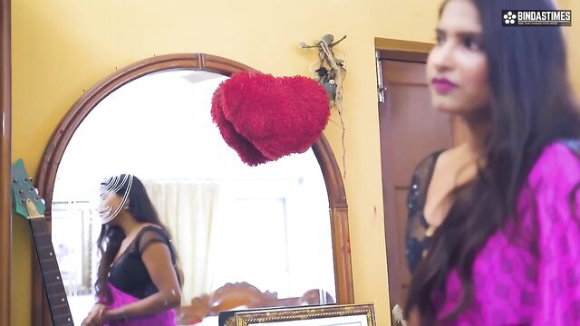 Sexy Indian bhabhi in pink saree admiring mirror reflection