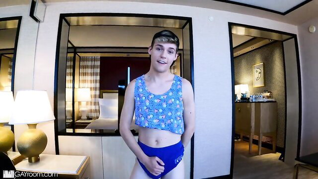 Pretty boy Jack in floral tank top and blue speedo, horny for cock