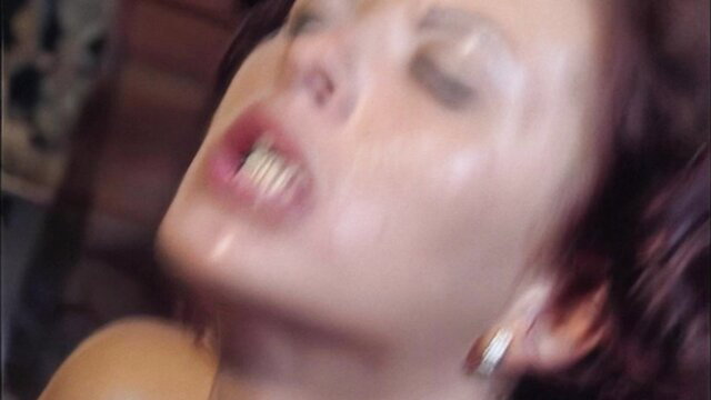 Closeup of aroused Asian woman with open mouth in intense sex scene from Mamma 1998