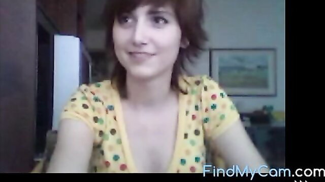 Cute brunette in polka dot top smiles teasingly from NubileFilms Super Oops