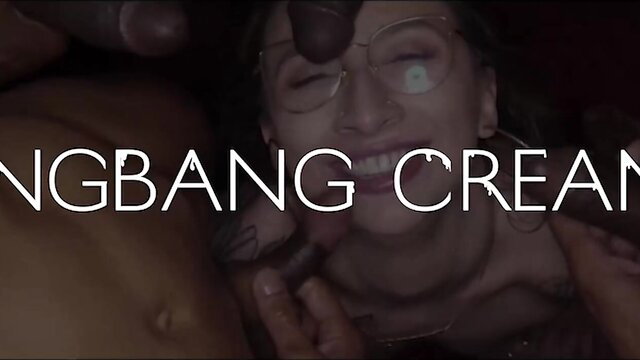 Juicy brunette with glasses in messy gangbang creampie, smiling with cum on face