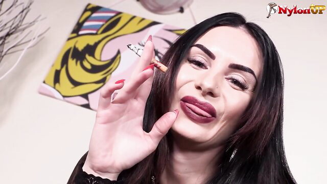 Sexy Ambra with plump lips smoking closeup, posing feet