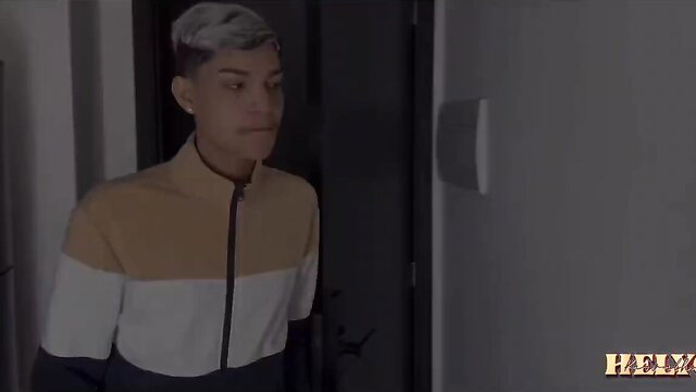 Gray-haired Asian twunk in orange-white track jacket stands seductively