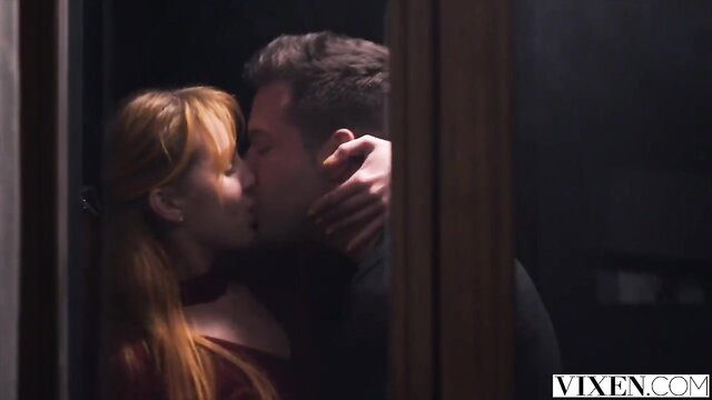 Little Dragon passionately kisses man in doorway, red hair & dress