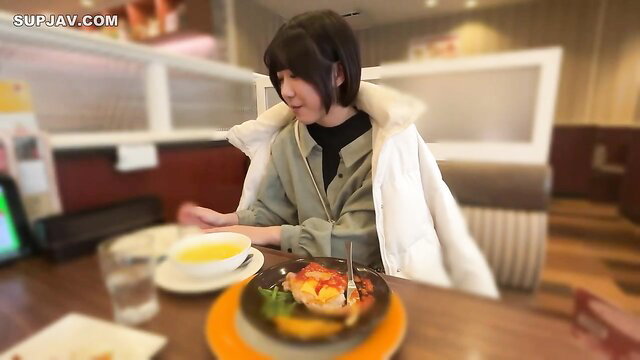23yo Japanese new grad in white puffy jacket eating at restaurant