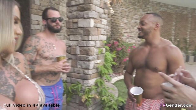 Tattooed shemale and buff guys in bikinis chatting poolside groupsex tease