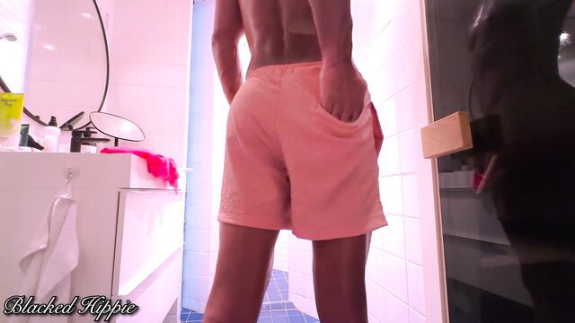 Fit black guy in pink H&M swim briefs, back view in sauna drag review