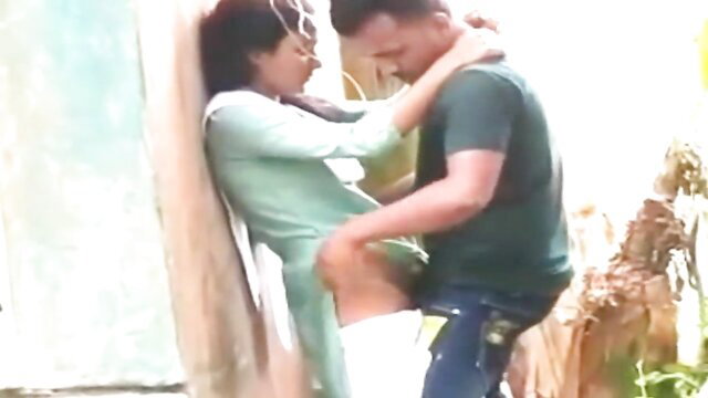 Desi Indian college couple outdoor sex, passionate embrace against tree