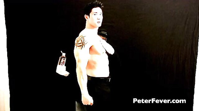 Tattooed Asian hunk flexing shirtless in black pants, Mystery Hands