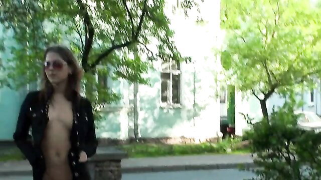 Skinny young exhibitionist flashes bare tits on street in open jacket