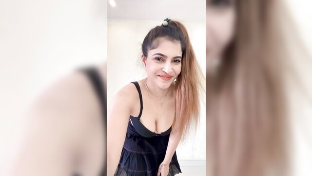 Desi Bhabhi Kari in sexy black tank top, smiling ponytail tease