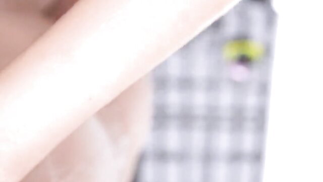 Blurry closeup of amateur Japanese girl's pale arm and plaid skirt in JAV sex video thumbnail