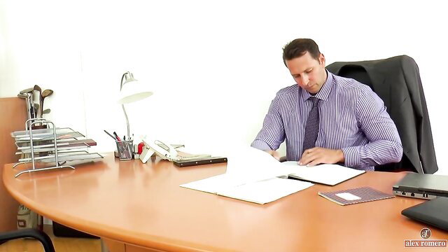Alex Romero at desk in office suit, Classix thumbnail