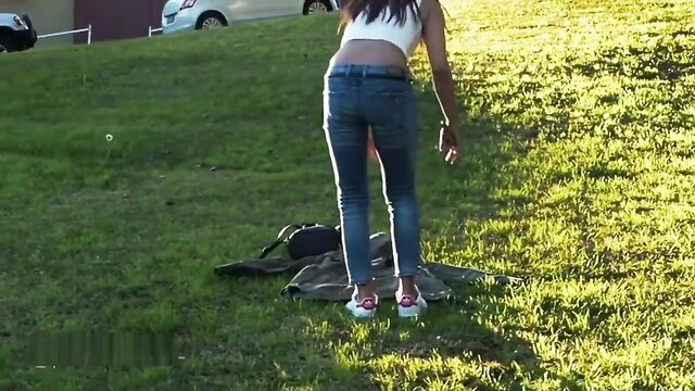Asian Tina in tight jeans bends over for risky public pee in park