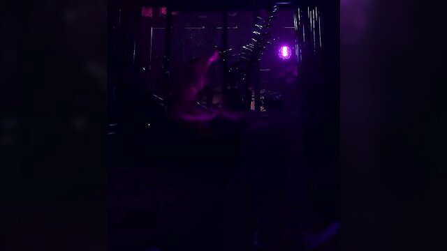 Mystery woman in dark purple-lit ritual with neon lights, erotic pose
