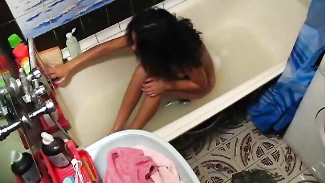 Brunette babe naked in tub on spy cam, wet curves exposed