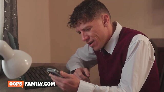 Rion King in white shirt and red vest texting, Hazel Moore Oops Family