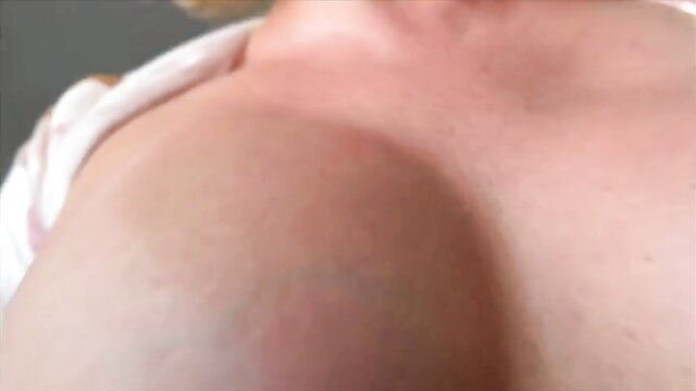 Blonde woman closeup on huge pale tits and neckline in sexy top