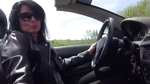 Insatiable brunette mature in leather jacket driving POV, teasing young hunk