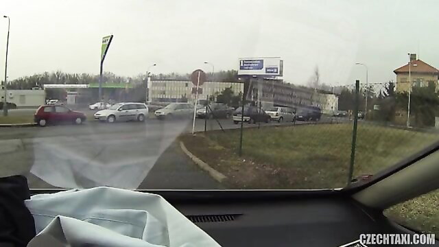 POV dashcam drive near Czech gas station, rainy urban street