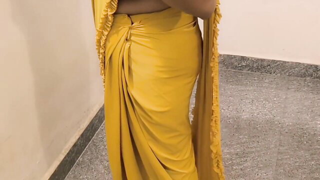 Indian bride in tight yellow draped saree showing curvy hips and meaty arse