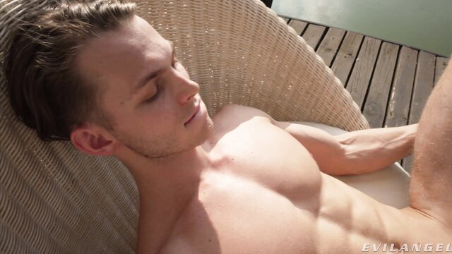 Nude muscular twink Tommy relaxing on lounge chair, Evil Angel