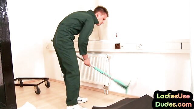Amateur Euro guy in green jumpsuit mopping floor bent over in pegging prep