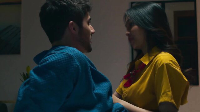 Asian couple in intimate bedroom talk, yellow dress and blue robe