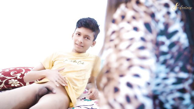 Young Indian twink exposing cock on bed, yellow tee lifted