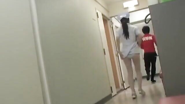 Asian nurse in white uniform with visible white panties sharking in hospital hallway
