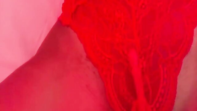 Closeup of woman in red lace lingerie masturbating