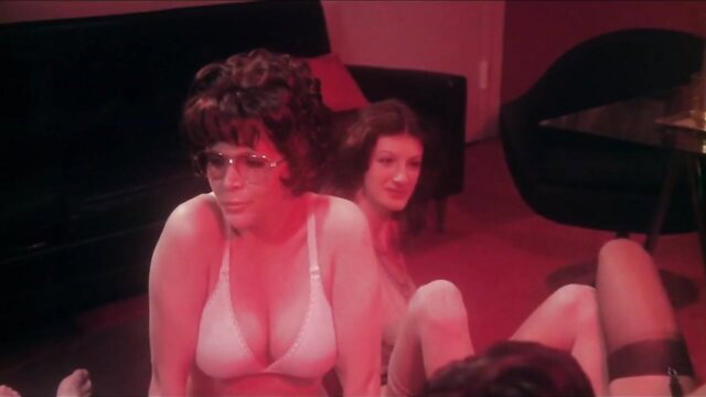 Jennifer Welles in vintage red room orgy, busty brunette in white bra lingerie