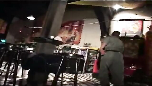 Asian bar scene with women in sexy dresses and uniformed man