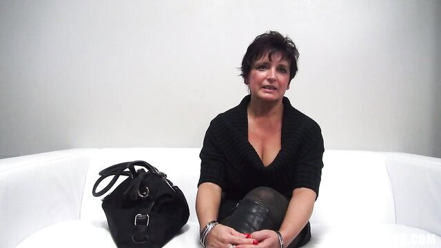 Mature Czech housewife in black top and stockings on white couch