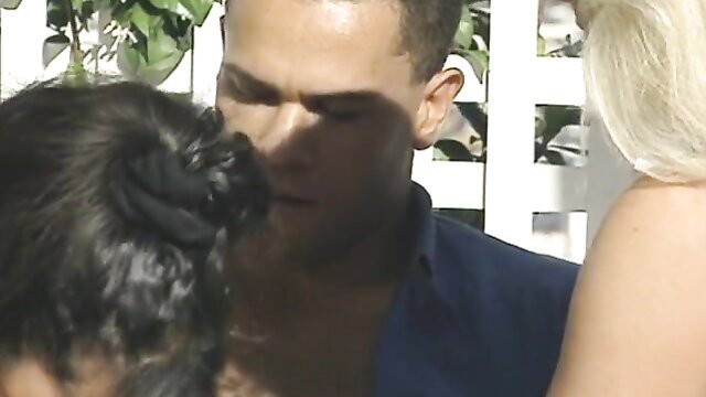 Retro 1995 threesome with blonde, brunette and man kissing dog outdoors