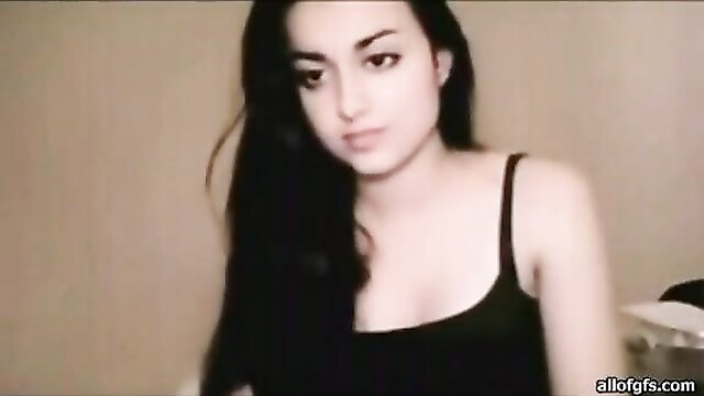 Charming Indian teen with long black hair in tank top on webcam