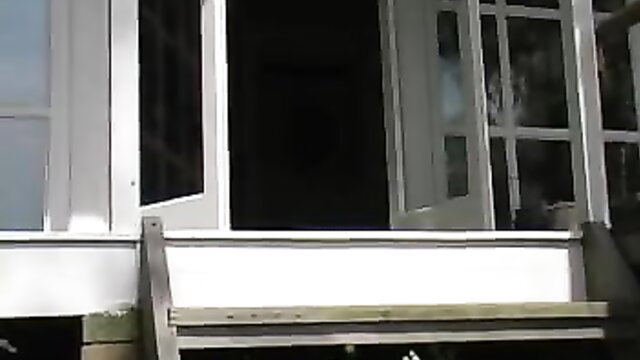 Boss Belle in Lethal Lipstick by open door on porch