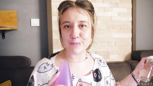 Proxy Paige in cat print top holds purple dildo and water bottle