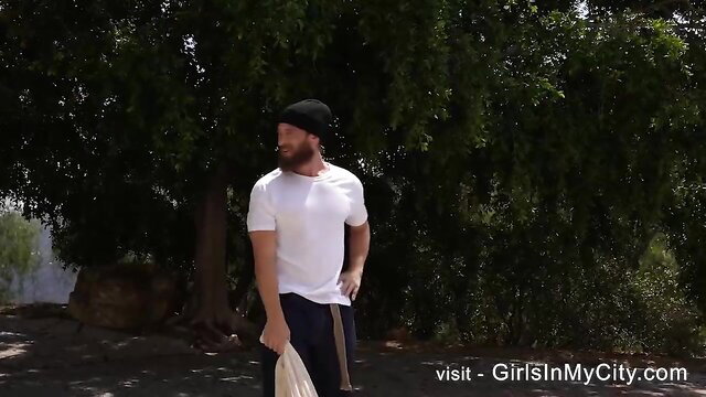 Bearded man in white tee and beanie outdoors - Amber Moore video